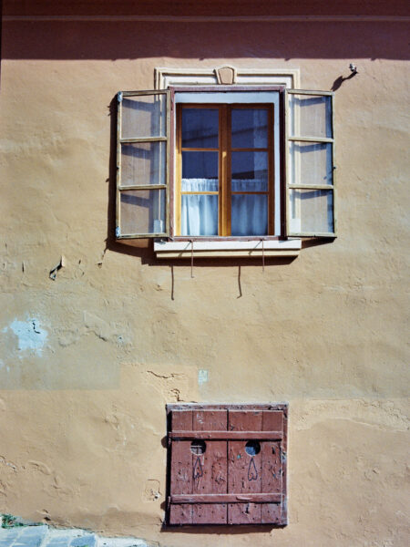 Fine art picture showing an old window watching the neighbourhood