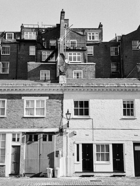 Fine art picture showing a conglomerate of houses watching the scene in black and white